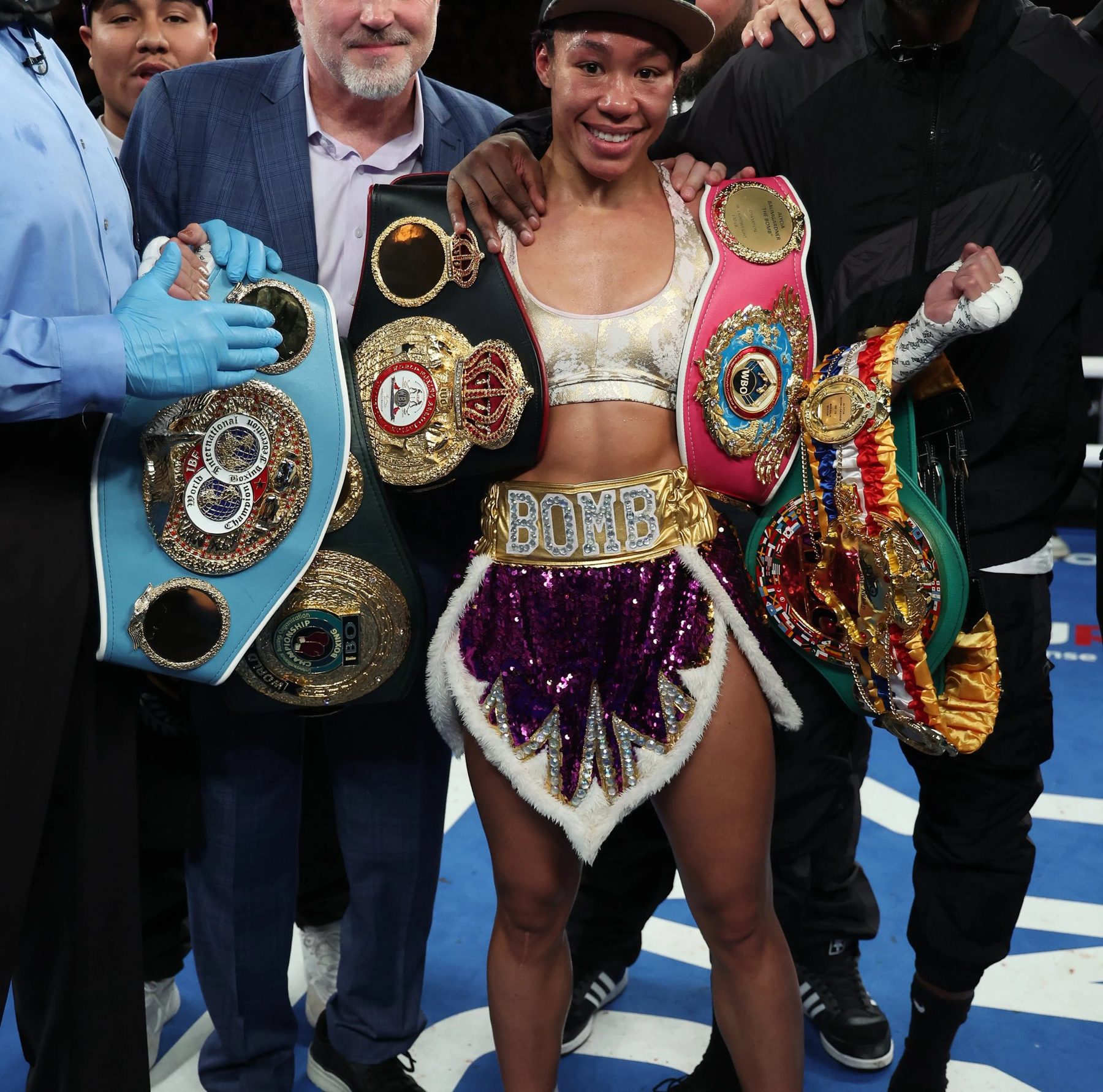Alycia Baumgardner in the ring with her championship belts